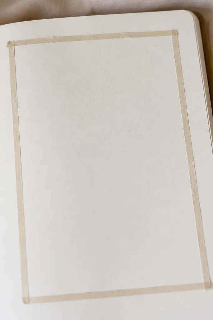 A journal page where the main writing block sits inside a rectangle frame made from thin washi tape. The tape has slightly uneven handmade edges, and the center is left open for handwriting.